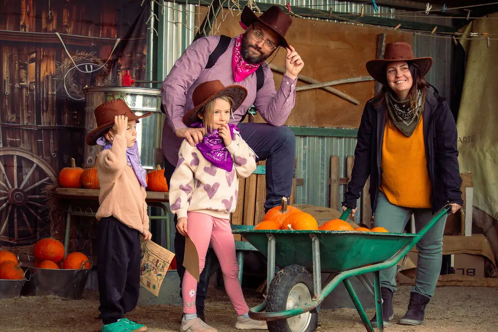 Familia con disfraces de vaquero en el fotocall